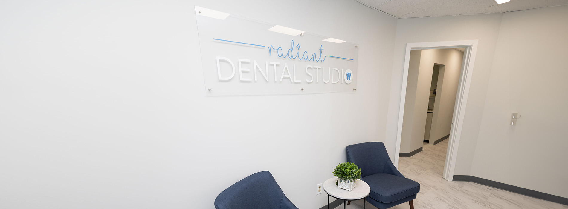 The image shows an interior space, likely a dental office or clinic, with a clean and modern design.