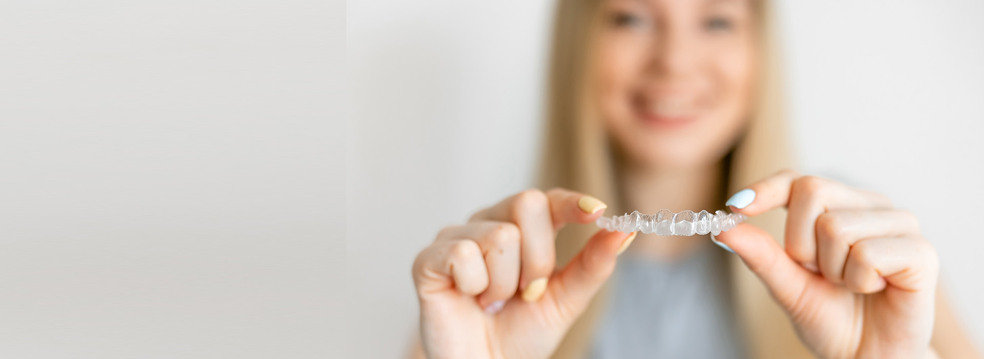 A person is holding a small, shiny object in their hand.