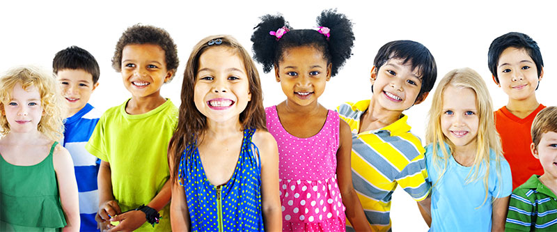 A group of diverse children posing for a photo with smiles, dressed in colorful clothing and accessories.